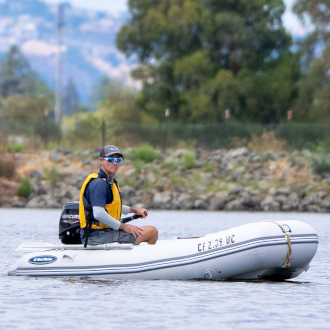 Sailing instructor driving a powerboat. Sailing instructor driving a powerboat.
